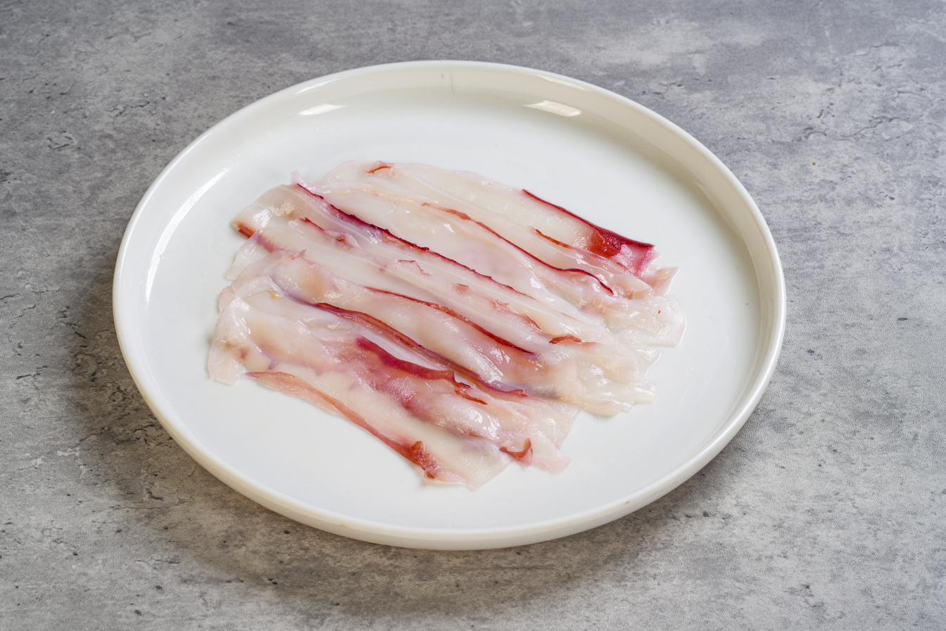 Paper-thin Squid — sliced thin for retail presentation